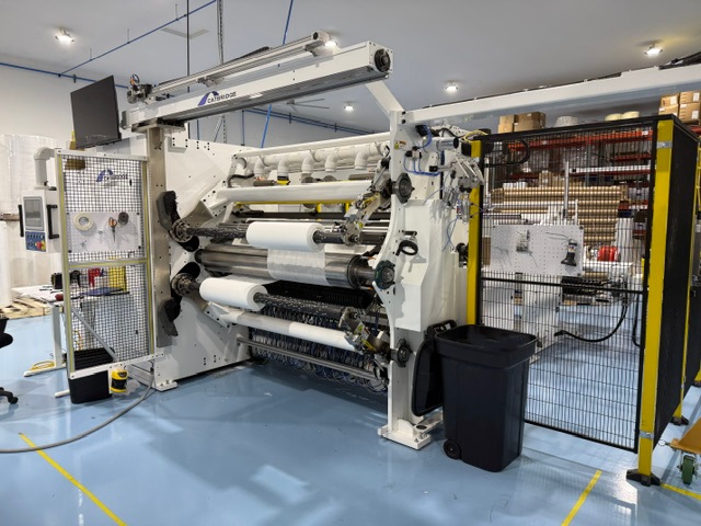 Catbridge Model 729-32 duplex slitter rewinder at Pepin Manufacturing with slit rolls on the rewind shafts and safety guarding at right