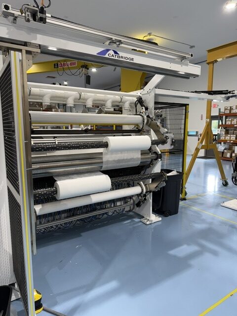 Front view of the Catbridge Model 729-32 slitter rewinder at Pepin Manufacturing showing finished rolls on the rewind shafts
